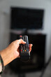 © FATIR29 - A person holds a TV remote control