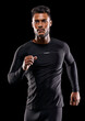 © peopleimages.com - Exercise, athlete and runner man in studio for sprint workout, marathon or competition with black background. Fitness, serious and male model person for speed, endurance training and wellness