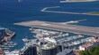 © 4kclips - Gibraltar International Airport runway intersecting with Winston Churchill Avenue and marina