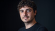 © Shelinaakter - Portrait of a young man with curly hair and a mustache on a black background professional headshot