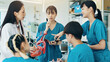 © peopleimages.com - Professor, students and heart for medical lecture, education or practical assignment in teaching hospital. Healthcare, learn and group with doctor for training on cardiac model at university in Japan