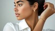 © Atthapon - A woman with a pearl earring and a gold bracelet