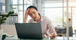 © peopleimages.com - Woman, headache and stress with laptop at office for glitch, error and lost profit with burnout at finance agency. Person, accountant and frustrated with migraine, pain and brain fog with glasses