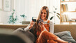 © peopleimages.com - Happy, woman and phone with credit card at house for payment, online shopping and banking information. Person. mobile app and pin for financial transaction, ecommerce purchase and investment website