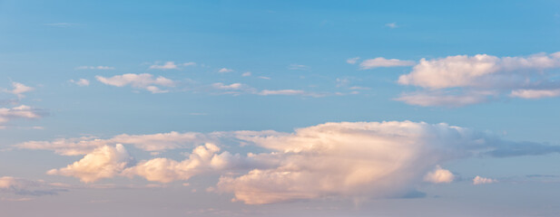 Wall Mural - Panoramic background of evening sky with beautiful clouds, soft contrast and pastel colours