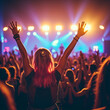 © Kolipatel - Crowd enjoying and putting hands in the air at a music festival with moving lights