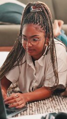 Fototapete - Research, student and woman with laptop, home and studying for assignment in lounge and online course. House, digital and black person with tech for elearning, typing and girl with glasses on floor