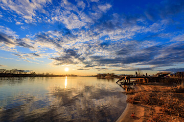 Wall Mural - the sky is blue and the sun is setting