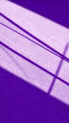 Wall Mural - Abstract purple wall with light and shadow patterns. Lines of light and darkness cross the textured surface in a geometric design.