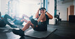 © Jessy/peopleimages.com - Fitness, exercise and sit ups with personal trainer, class and gym for training or workout routine. Coaching, goals and target with group of sports people in health club together for core muscle