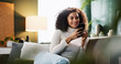 © peopleimages.com - Relax, message and woman with smartphone, home and smile for communication with contact and online. Comfortable, reading and person with mobile for chat, happy and girl with tech for texting in house