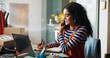 © peopleimages.com - Woman, phone call and writing notes for small business, courier service and schedule of delivery. Person, mobile discussion and information for fashion order, inventory management and stock feedback
