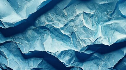 Wall Mural - crumpled blue paper texture with organic patterns and waves in a calming shade of blue