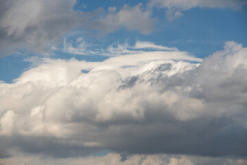 Wall Mural - blue sky with fluffy white close up clouds.
