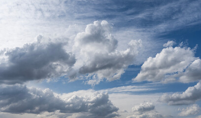 Wall Mural - blue sky with fluffy white close up clouds.
