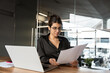 © Stock 4 You - Focused latin or arabian young business woman hr working on laptop computer reading finance document report, cv contract in office. Accountant saleswoman manager businesswoman doing paperwork using pc