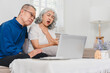© PRIME STOCK LAB - elderly couple consults doctor via online video call, with woman showing discomfort and holding her throat