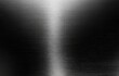 © ken - Brushed metal surface texture.  A sleek, dark gray metal panel with subtle light reflections creating a brushed effect.  The surface appears smooth and polished, showcasing a high-quality finish