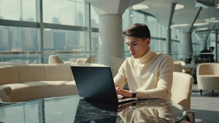 Wall Mural - a person sitting at a desk with a laptop, likely working or studying.