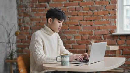 Wall Mural - a person sitting at a desk with a laptop, great for any article or presentation about technology and