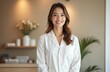 © miss irine - Smiling spa salon receptionist, dressed in white uniform, welcoming clients. Happy female staff member in beauty center, wellness treatment at resort. Service, client oriented spa day. Portrait.