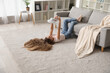 © Pixel-Shot - Teenage girl lying on floor with electric fan in living room