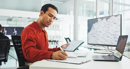 Poster - Computer screen, tablet and wind turbine with man writing in office for renewable energy or sustainability. Ecology, notebook and windmill with map on display for design, development or engineering