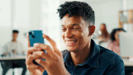 Poster - Business, man and smile with phone in office for text message, good news or reading client email. Journalist, employee or typing on smartphone for article research, check notifications and web scroll