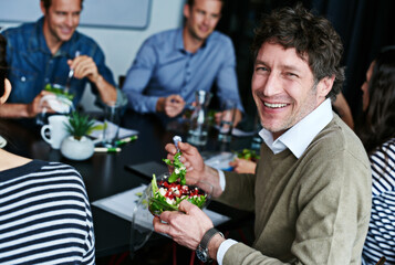 Aufkleber - Meeting, eating and portrait of businessman with salad in office for team building lunch for collaboration. Discussion, smile and male designer with colleagues enjoying healthy meal in workplace.