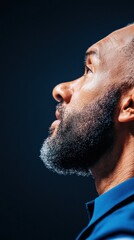 Poster - Resilient Leadership Profile Cinematic Closeup of Professional Black Male Executive in Vibrant Blue - Authentic Workplace Diversity and Empowerment Imagery