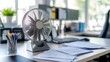© Pannee - Desk fan blowing papers lightly on a clean, organized desk
