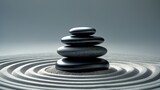 Zen garden backdrop featuring a stack of black stones on sand.