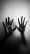© barinovalena - the hands of a person are pressed against the glass, the silhouette of the body is barely visible, the concept of a state of mind, loneliness, anxiety, hopelessness, danger, help