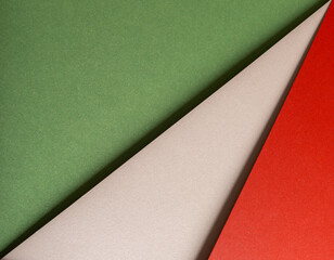Aufkleber - Paper background with matte texture. Layered diagonal sheets in crimson red, pastel green, mint green, soft beige, and champagne tones, elegant vibrant composition, festive stylish contrast..
