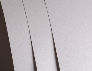 Aufkleber - White pearl paper background with a glossy satin texture and layered strips in a flowing, balanced layout. Icy silver and pale grey hues create a soft, elegant, and luxurious abstract design with.