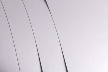 Aufkleber - White satin paper background with a glossy, smooth texture and layered strips. Pale grey and icy silver tones create a clean, elegant, and luxurious abstract composition with subtle curves, gentle.