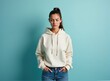 © Collse - A woman in a hoodie and jeans expressing depression, standing in front of a pastel blue background with studio lighting, realistic photo, centered composition, 4k, shallow depth of field. Mockup.
