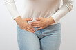 © TSViPhoto - Woman holding lower abdomen from side. Pain or spasm. Gynecological problems or appendicitis