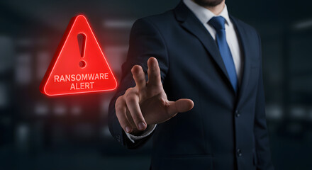 A businessman warns about ransomware with a red alert symbol, highlighting a serious cybersecurity threat.