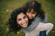 © Khawla - Happy indian mother having fun with her daughter outdoor - Family people and love concept - Focus on mum face