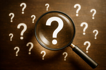 Fototapete - Magnifying glass focusing on question mark surrounded by more question marks on wooden background symbolizing search, doubt, and research concept.