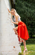 © Andrey_Arkusha - Portrait of a young beautiful blonde woman in a long red skirt