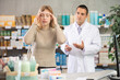 © JackF - Girl visits pharmacy and suffers from headache pain. Customer is looking for affordable remedy to relieve cold symptoms, man pharmacist performing help and consulting