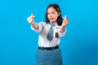 © Saddha Visual - Cheerful Indonesian high school student smiling while making a finger heart gesture. Her bright expression and confident pose reflect friendliness, fun, and youthful charm.