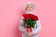 © New Africa - Senior man with bouquet of red roses on pink background