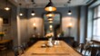 © Blur Bokeh - Blurred dining room with rustic table, hanging lights, and muted decor