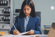 © ARMMY PICCA - Portrait of Asian young female working on laptop at office