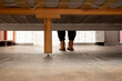 © Виктория Котлярчук - View of the legs of a girl from under the bed who is sitting on the bed at home in the bedroom, legs under the bed, legs
