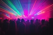 © Roshani - A vibrant crowd enjoys a laser show at a concert, bathed in pink and green lights.