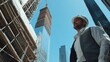© Mcgui - Construction manager inspecting building progress from scaffolding. Featuring oversight and construction planning